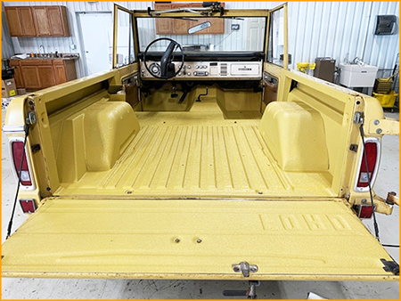 70's Bronco interior floor and bed sprayed with GatorHyde polyurea basecoat and topcoated with Golden Rod automotive urethane paint.