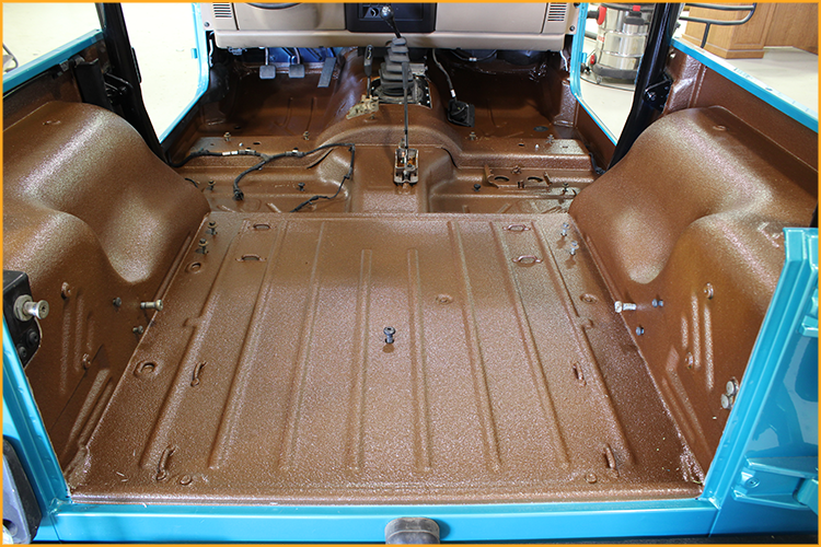Jeep interior floor lined with GatorHyde and topcoated with a tan aliphatic automotive spray
